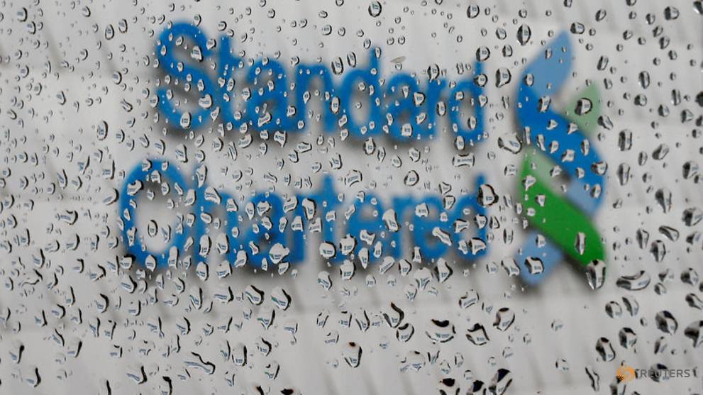 file-photo--a-standard-chartered-logo-at-its-headquarters-is-seen-through-a-window-with-raindrops-in-hong-kong-3.jpg