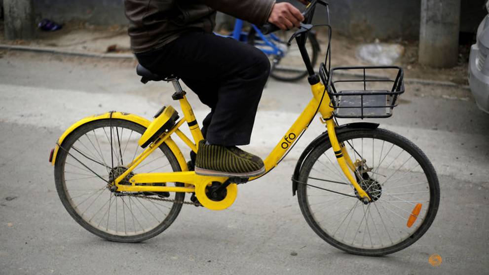 man-rides-an-ofo-bike-sharing-bicycle-in-a-village-on-the-outskirts-of-beijing-1.jpg